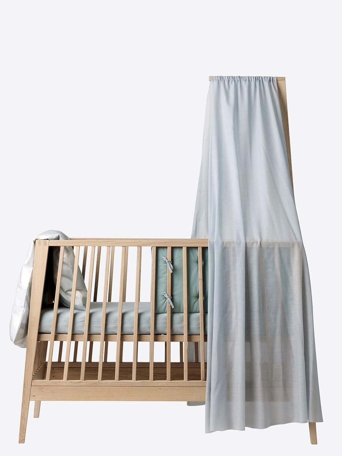 Leander Luna Baby Cot in White Oak, showcasing elegant design and craftsmanship.