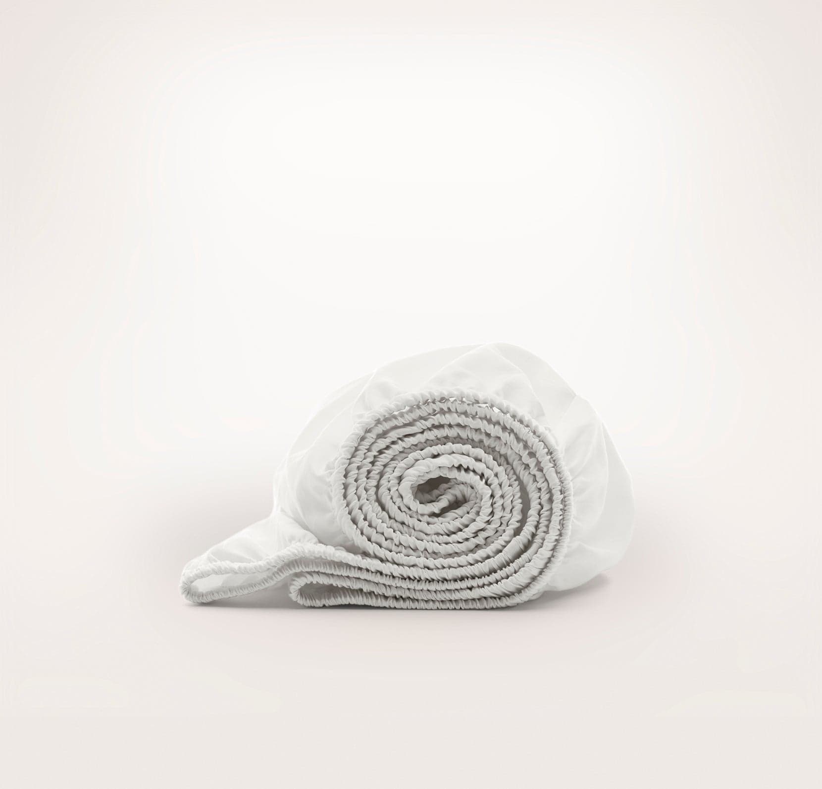 Boll & Branch Organic Cotton Crib Sheets laid out on a crib mattress.