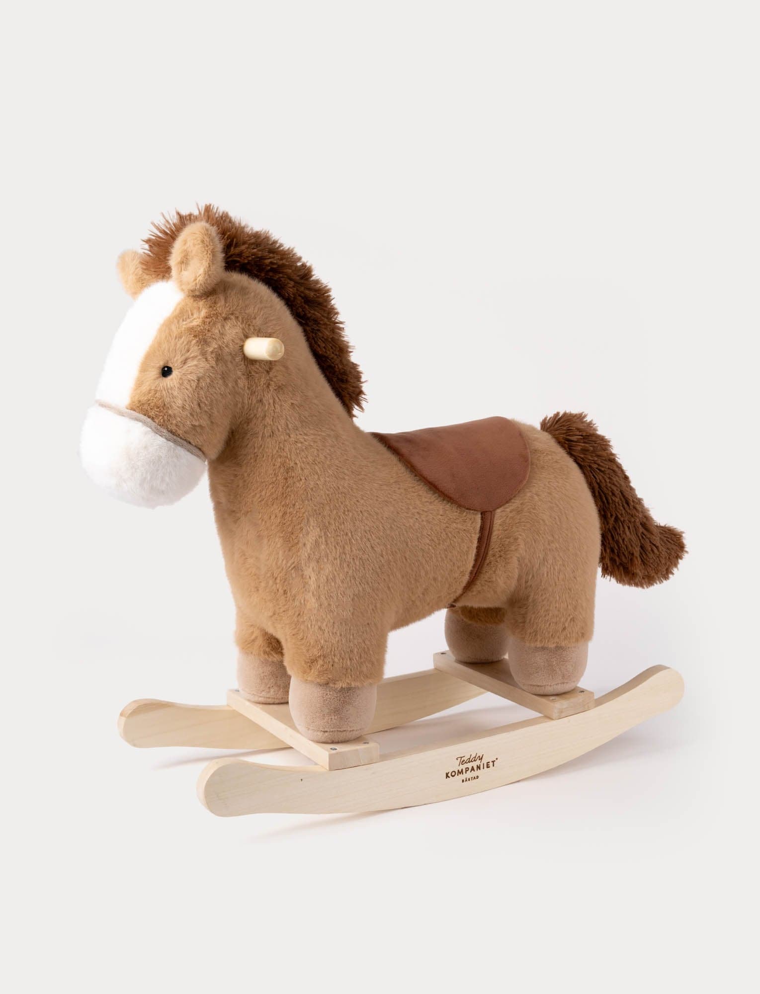 Wooden rocking horse from Teddykompaniet, soft plush features.