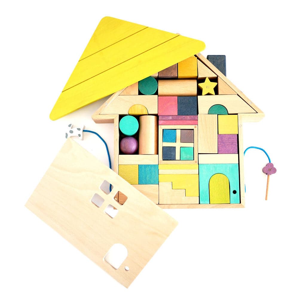 kiko+ & gg* Tsumiki House Building Blocks in soft colors on a wooden surface.