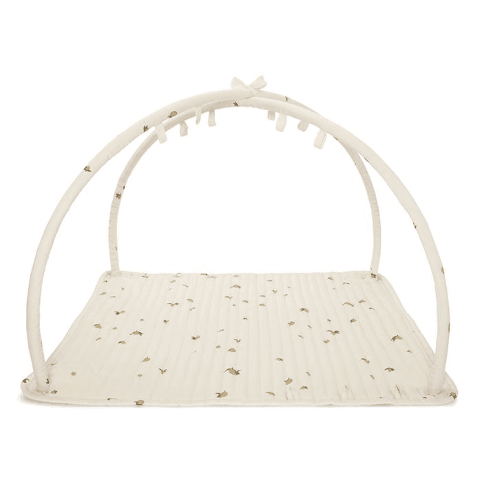 Konges Slojd play mat with baby gym featuring arches and toys.