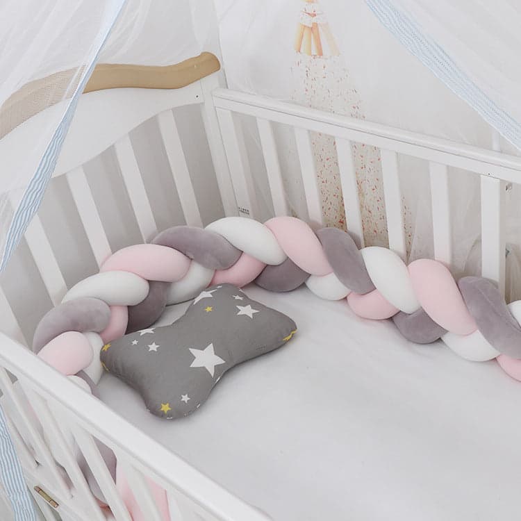 Three strands braided crib bumper in soft colors for nursery safety.
