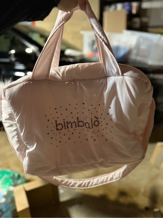 Bimbalò light pink diaper bag showcasing elegant design and spacious compartments.
