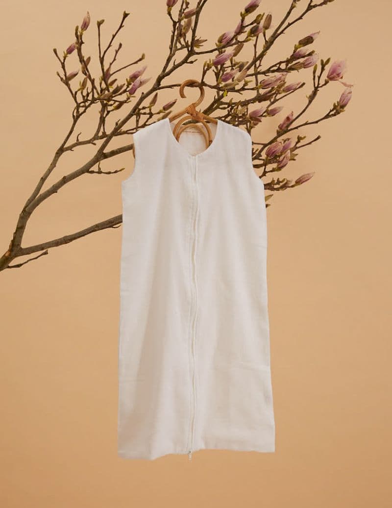 Khasto Baby Slaapzak in white made from soft cotton cashmere-like material.