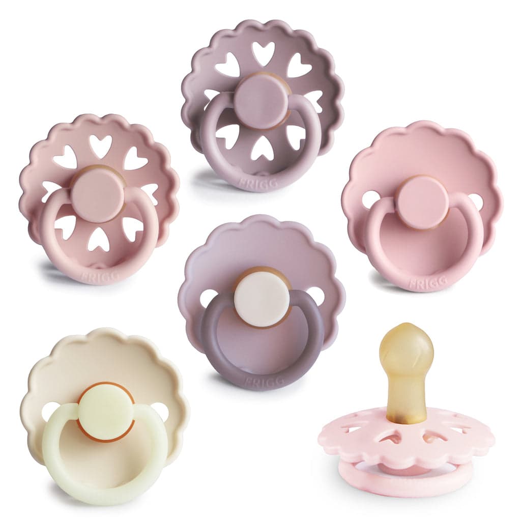 Mushie FRIGG Natural Rubber 6-Pack pacifiers in a minimalistic setting.