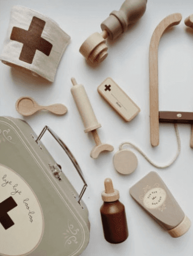 Konges Slojd Wooden Toy Doctor Set displayed on a light surface.