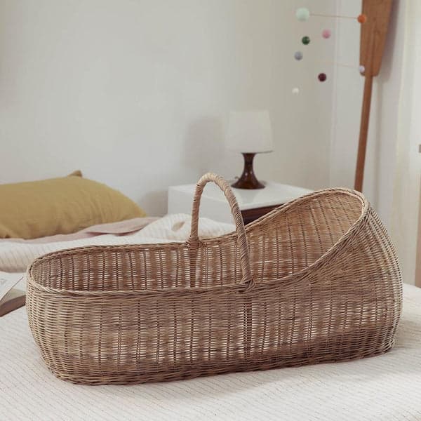 Olli Ella Lyra Moses Basket made of natural rattan with organic cotton mattress.